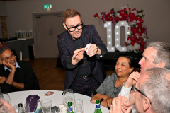 Magician in action taken on-location at Corporate 10 year event
