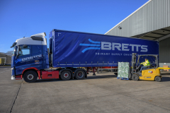 Fork lift truck loading pallet onto lorry