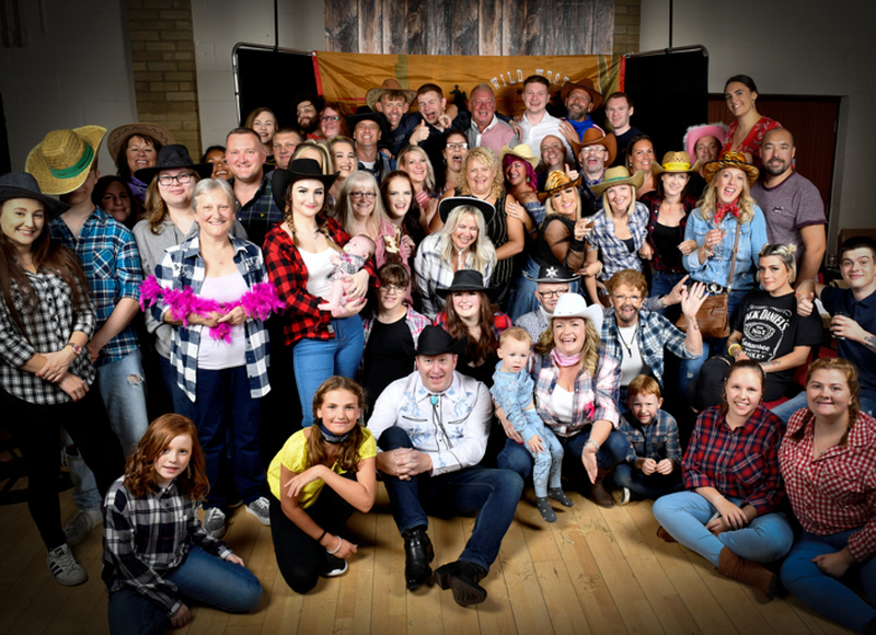 Special event photograph of very large group of friends in western costume photographed by image and events photography in Peterborough, Cambridgeshire