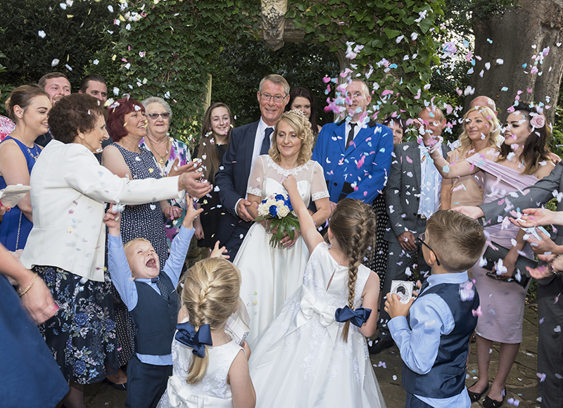 Bride and Groom wedding image showing happy couple celebrating with family taken by image and events photography in Peterborough