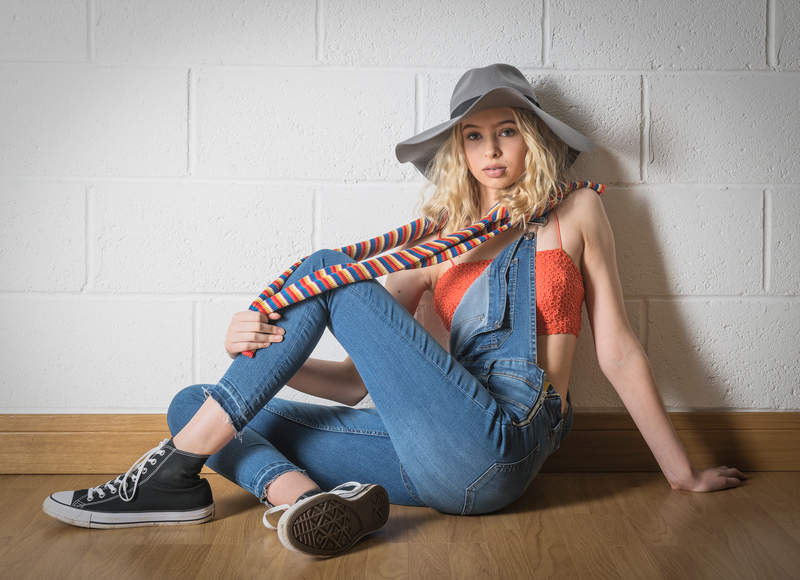 Model Picture of woman in hat against a white wall photographed in the studio of image and events photography in Peterborough