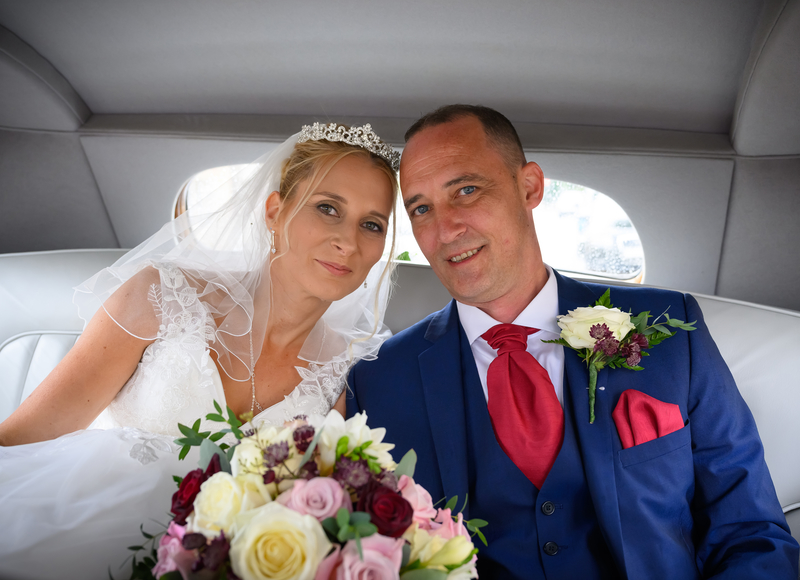 Wedding Bride and Groom photographed in back of wedding car by image and events photography in peterborough